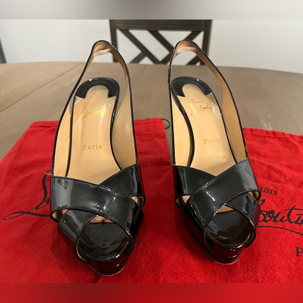 Christian Louboutin classic leather black crisscross peep toe sling back heels.